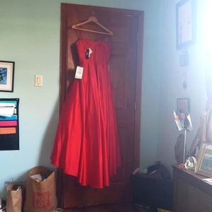 Betsy & Adam red strapless gown from Macy's .  Size 10 New with tags. Never worn